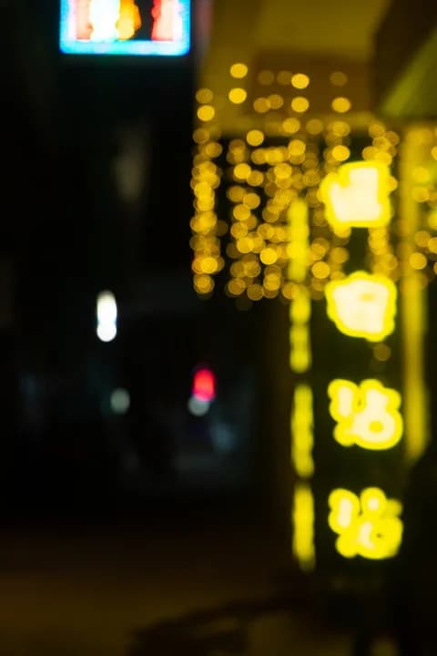 Blurred neon lights create a vibrant urban atmosphere at night. PNG