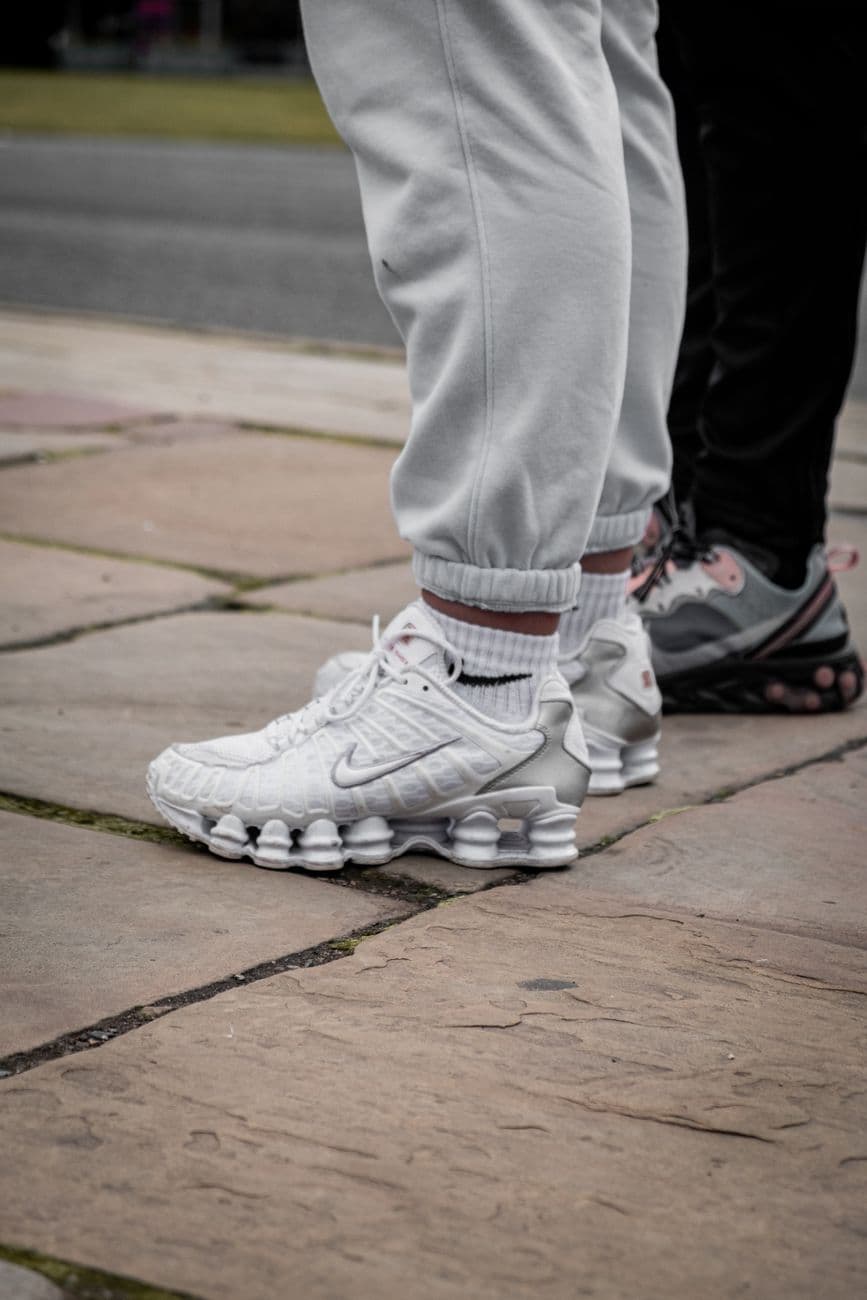 Close-up of trendy sneakers worn outdoors, showcasing street fashion.