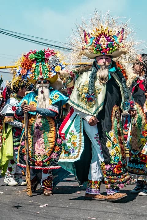 Vibrant Mexican costumes at a cultural festival parade outdoors. PNG
