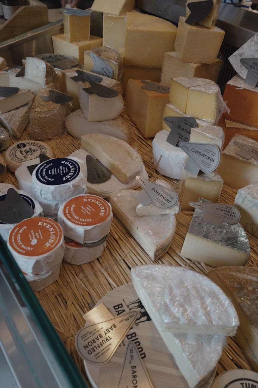 A variety of artisan cheeses displayed in a rustic setting, highlighting diverse textures