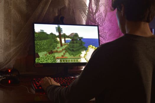 A young man intensely playing a PC video game indoors. Capturing the essence of technology PNG
