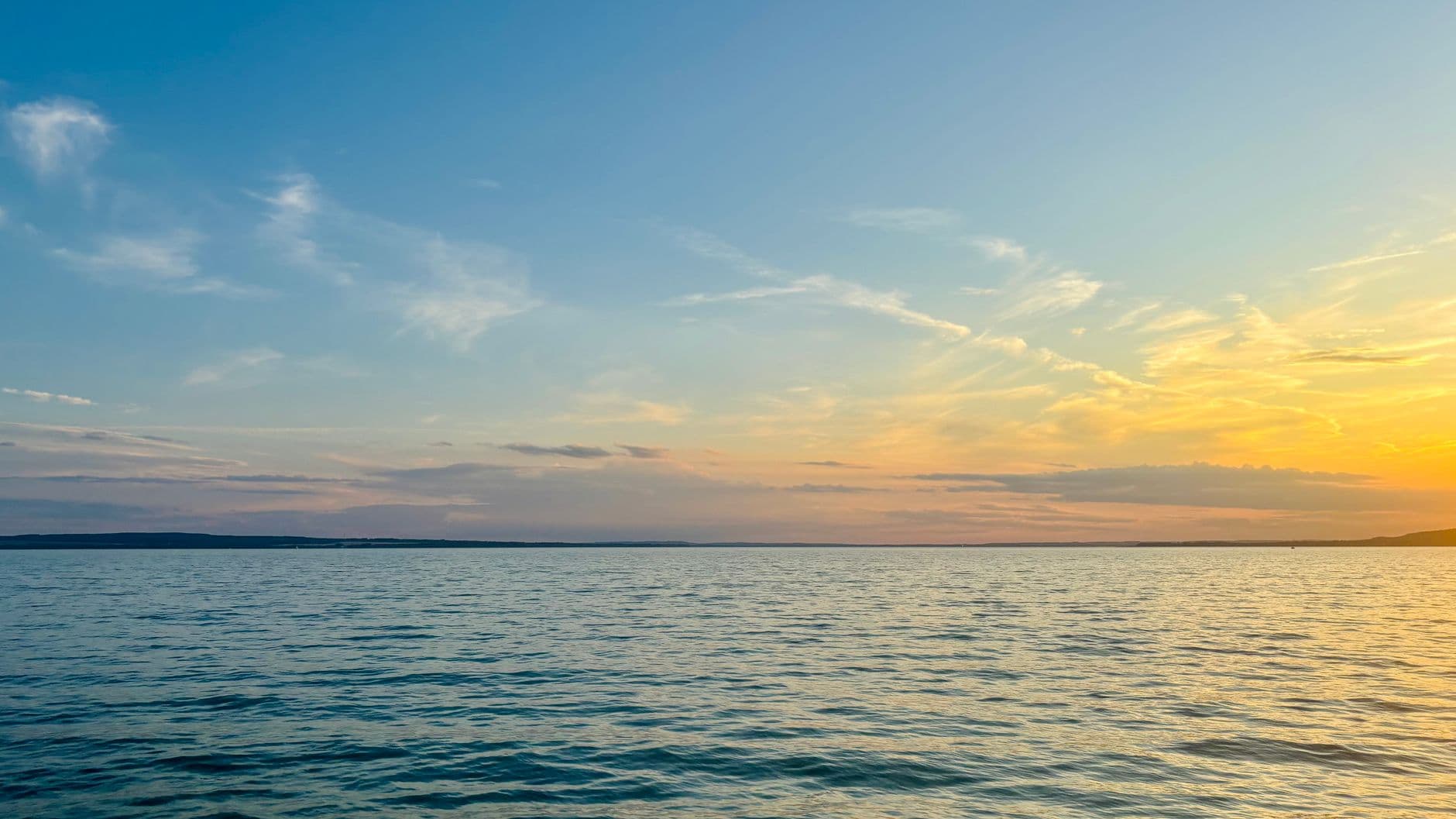 Beautiful sunset over Lake Balaton in Hungary, capturing serene water and colorful skies.