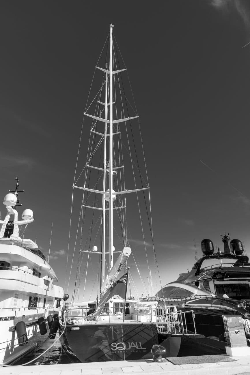 Black and white photo capturing luxury yachts at the harbor in Monaco, showcasing nautical