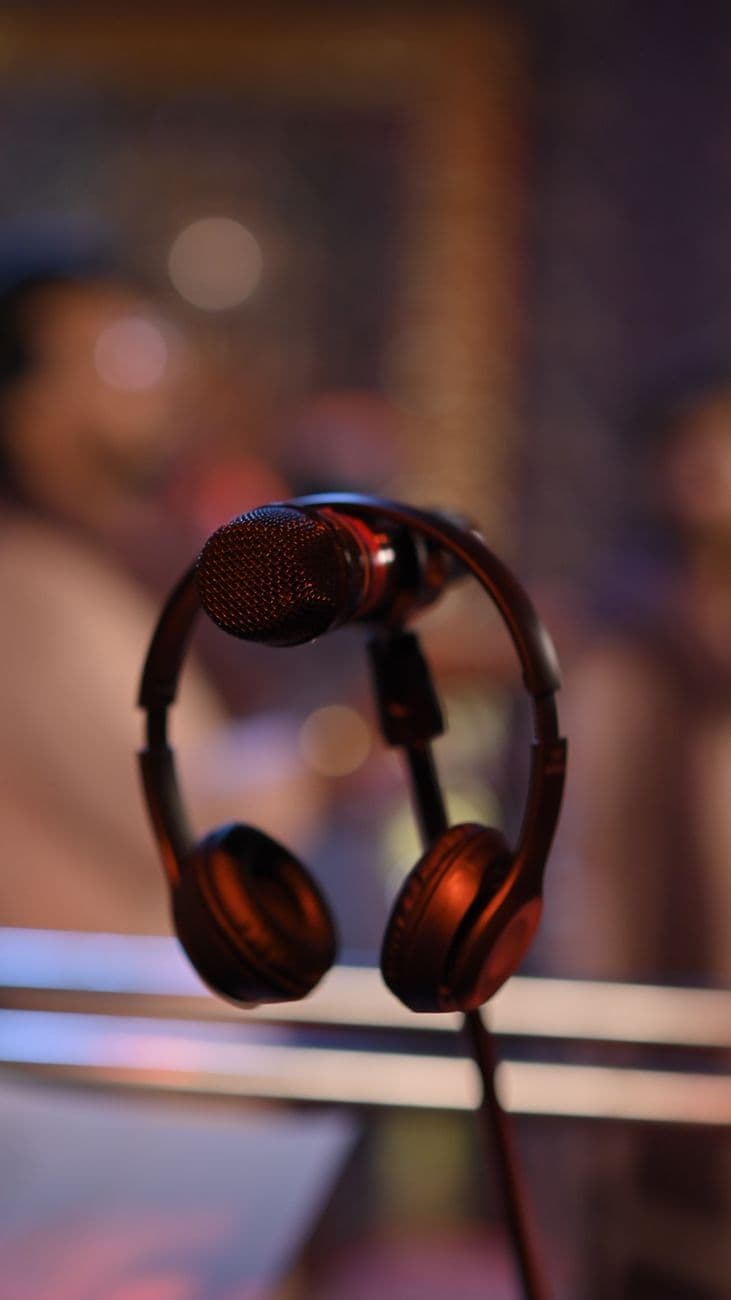 Close-up of a microphone and headphones in a music studio setting creating a professional