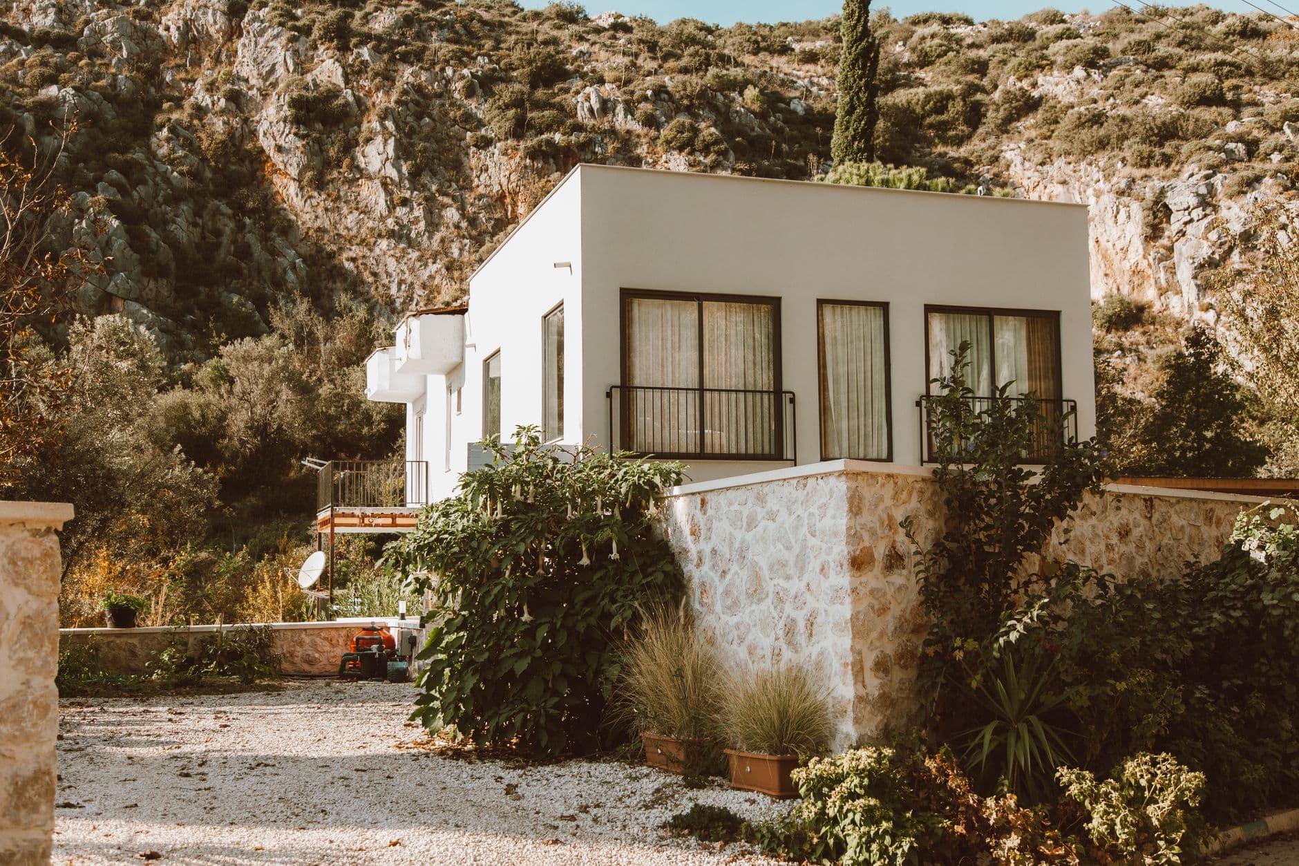 Contemporary house nestled in a sunlit rocky outdoor setting, perfect for architecture lov
