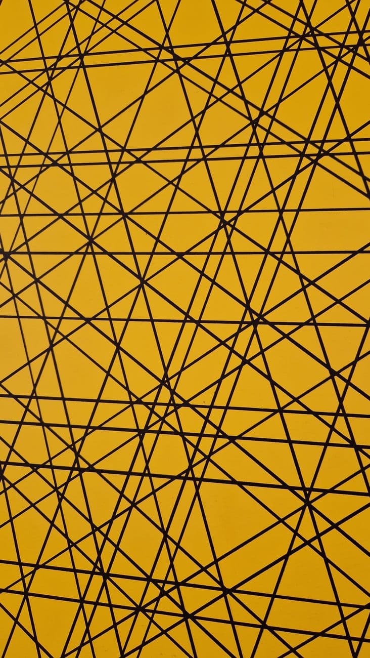 Dynamic abstract pattern of black geometric lines intersecting on a vibrant yellow backgro