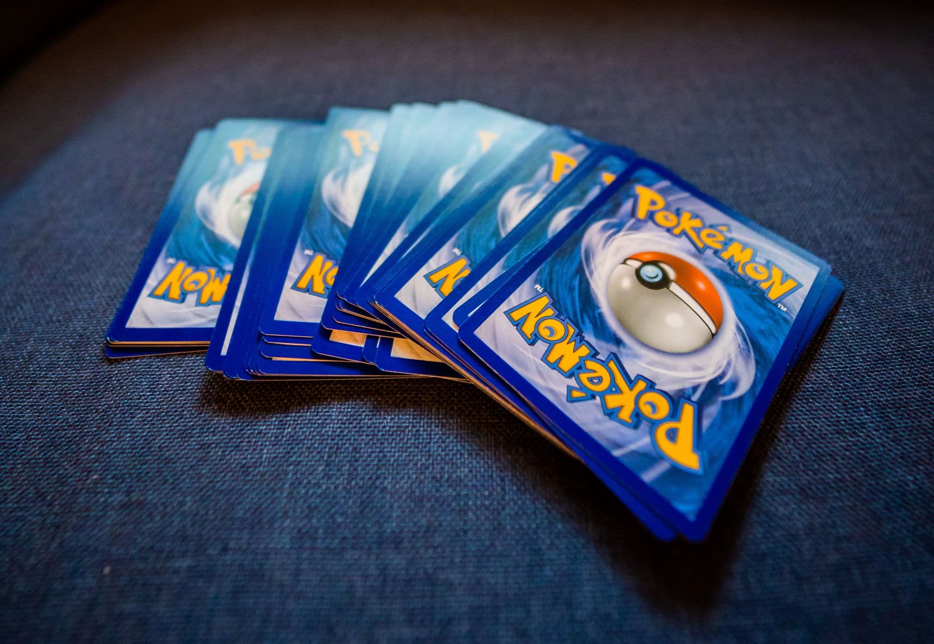 From above of pack of collectible cards with images of fantastic creatures on backs locate