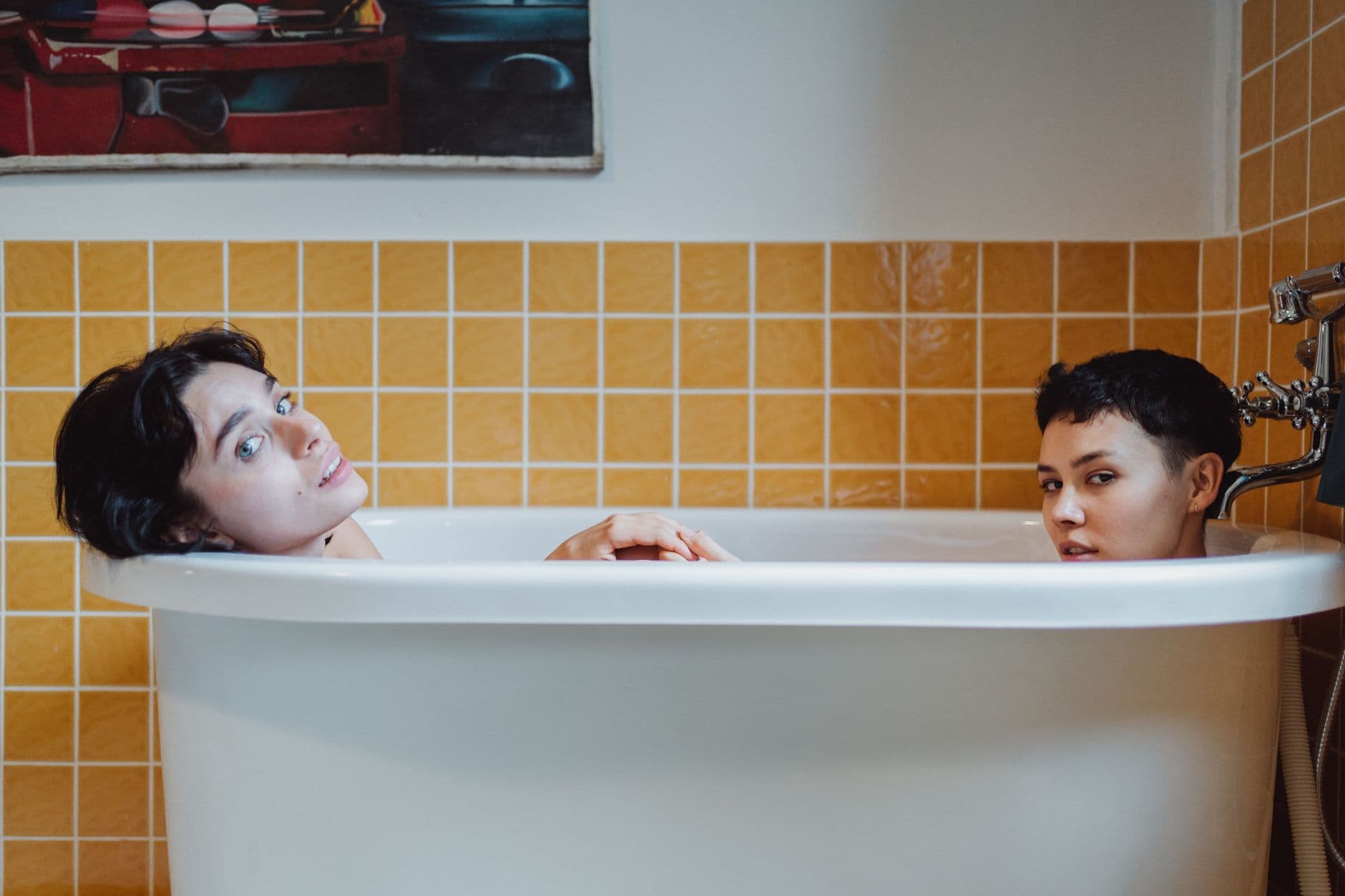 Intimate couple enjoys relaxation in a stylish bathtub, highlighting love and togetherness