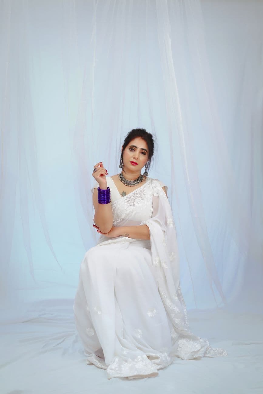 Stunning Indian woman in a white saree, showcasing traditional elegance with modern flair.