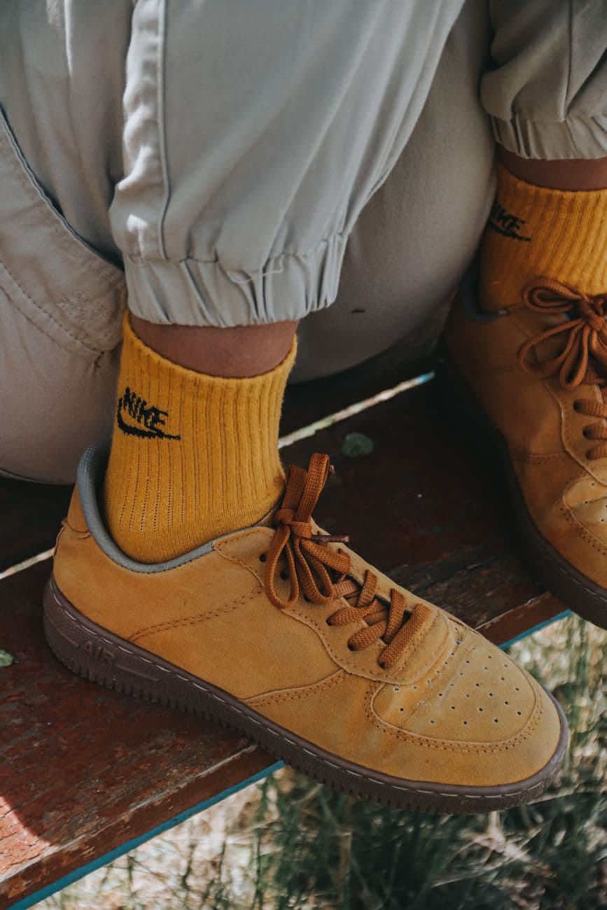 Stylish yellow sneakers paired with matching socks for a trendy streetwear look.