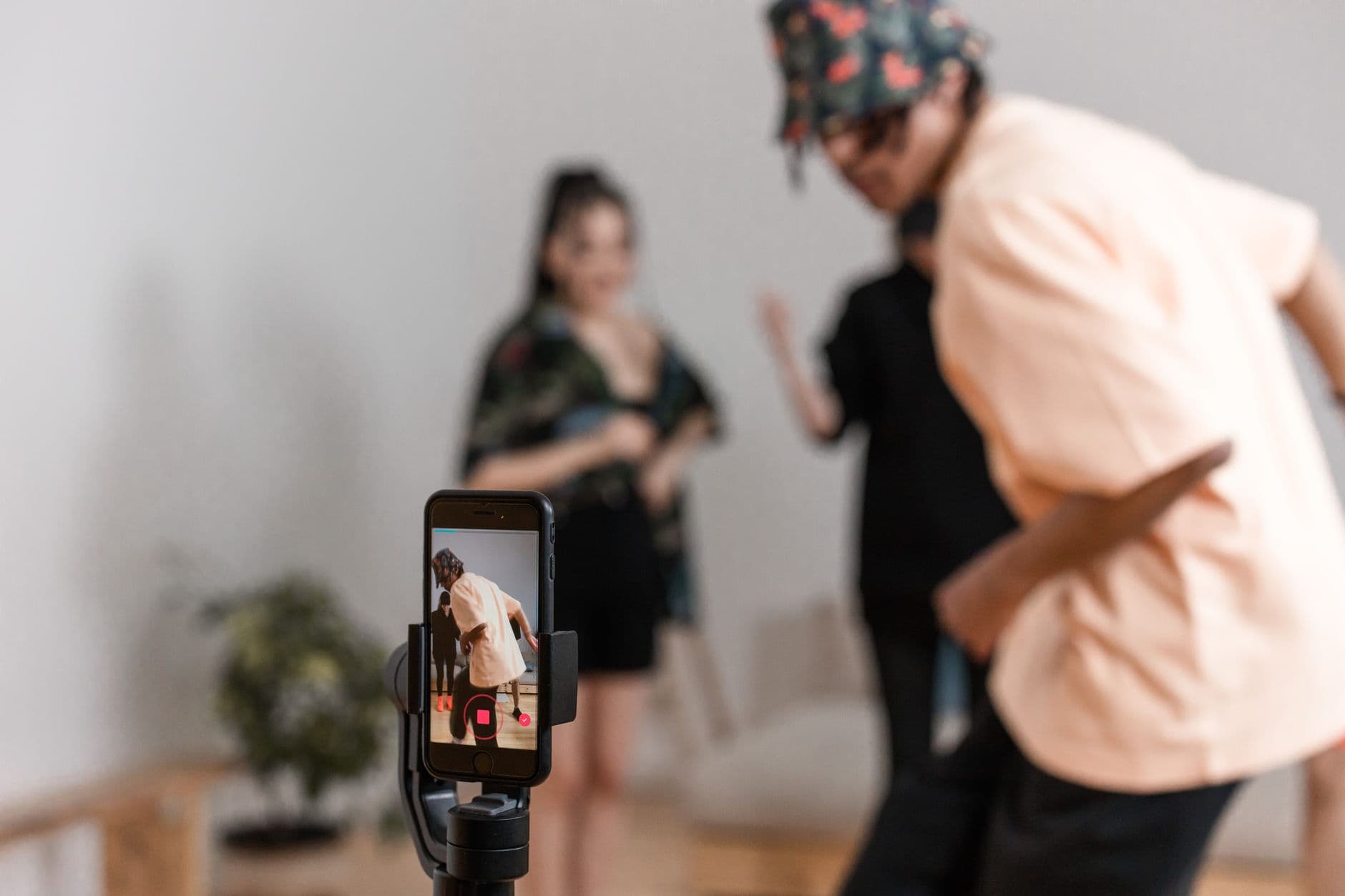 Vibrant indoor scene of people dancing recorded on a smartphone for a social media platfor