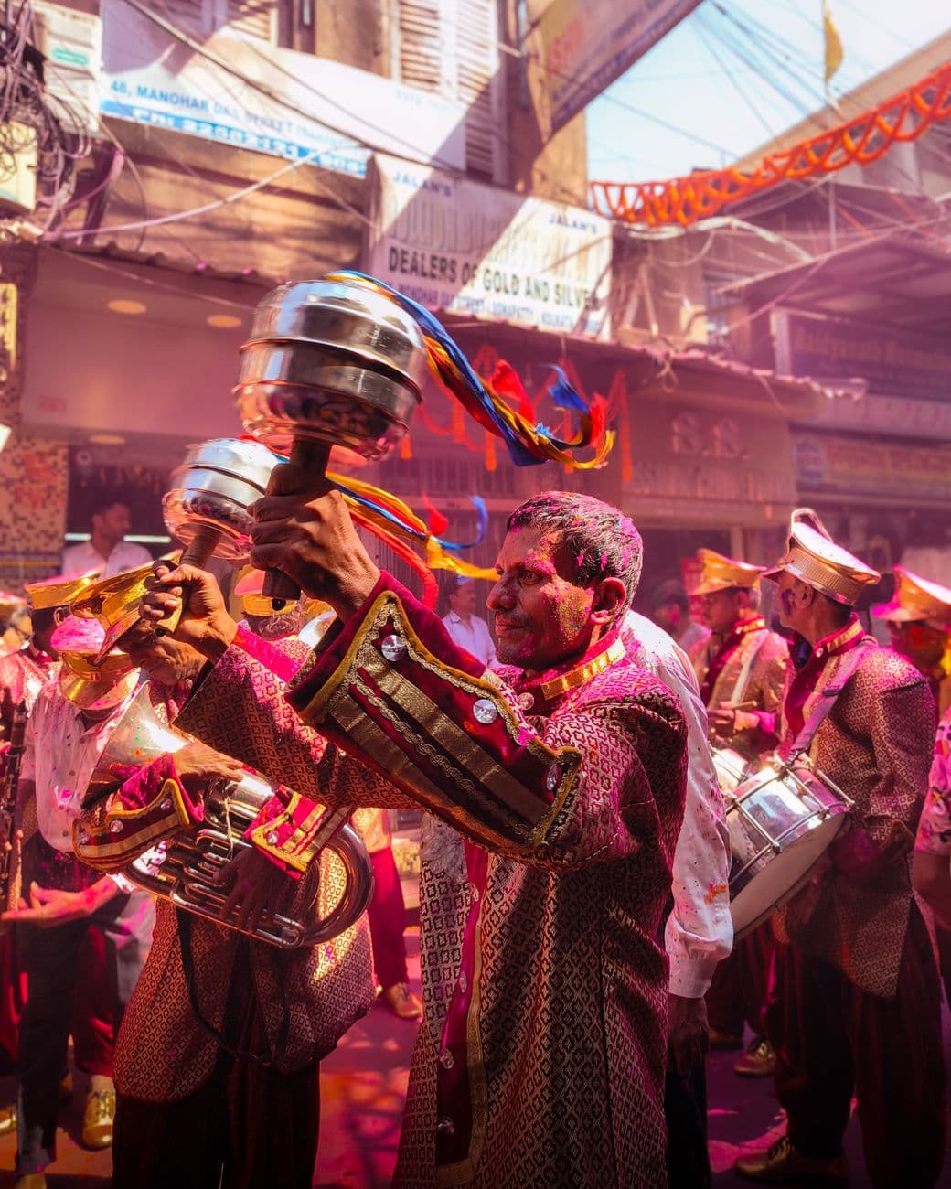 Vibrant street parade with traditionally dressed musicians in India, celebrating with musi