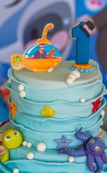 Vibrant underwater themed cake with fondant sea creatures for a birthday celebration. PNG
