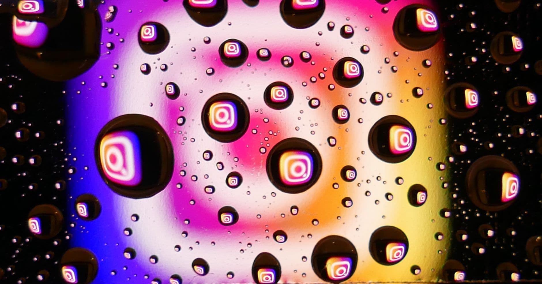 Vibrant water droplets on a colorful background reflecting Instagram logos, showcasing abs